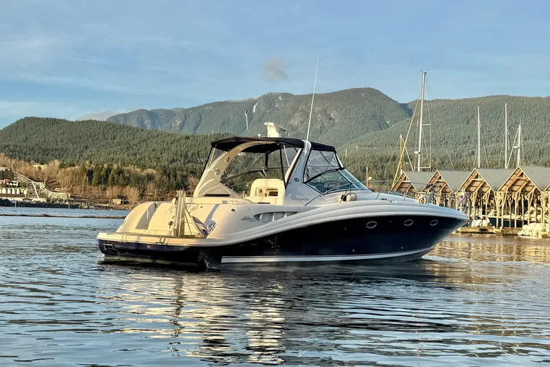  Yacht Photos Pics 2004 Sea Ray 420 Sundancer yacht on calm water with scenic mountain backdrop.