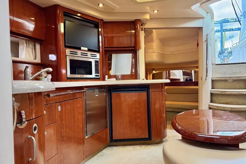  Yacht Photos Pics Luxurious interior of 2004 Sea Ray 420 Sundancer yacht with modern kitchen amenities.
