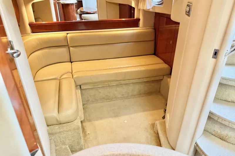  Yacht Photos Pics 2004 Sea Ray 420 Sundancer interior with beige leather seating and carpeted flooring.