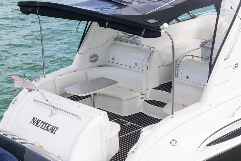  Yacht Photos Pics 2005 Formula 48 Yacht with spacious deck and seating, docked on calm water.