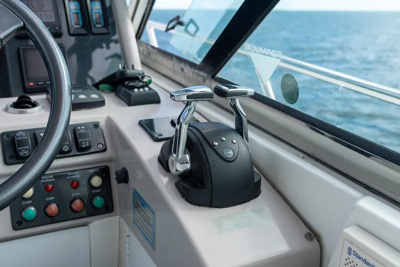  Yacht Photos Pics Control panel of a 2005 Formula 48 Yacht, featuring throttle levers and navigation instruments.