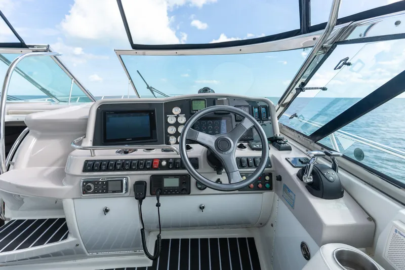 Yacht Photos Pics Cockpit of 2005 Formula 48 Yacht with steering wheel and navigation controls.
