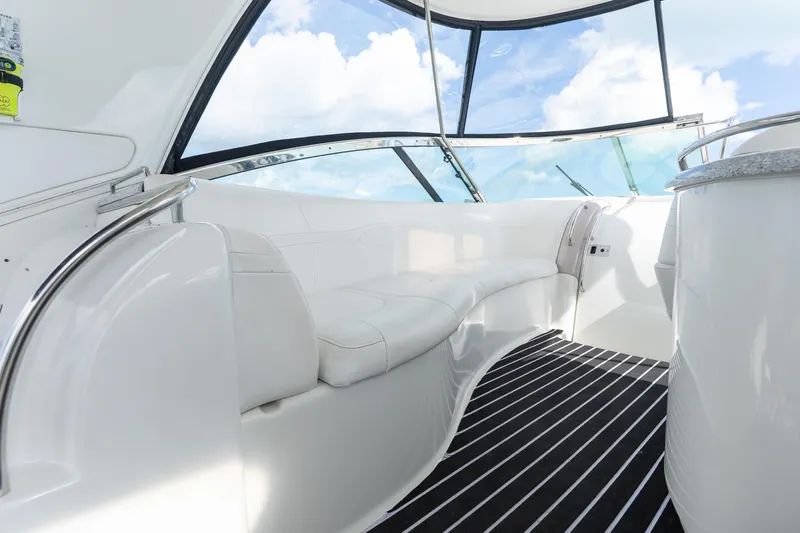  Yacht Photos Pics Luxurious interior of 2005 Formula 48 Yacht with white seating and panoramic windows.