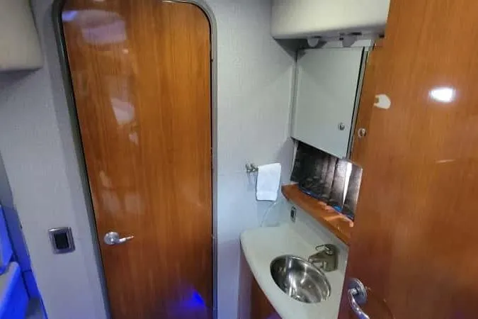  Yacht Photos Pics Interior of 2005 Formula 48 Yacht bathroom with wooden door and compact sink.