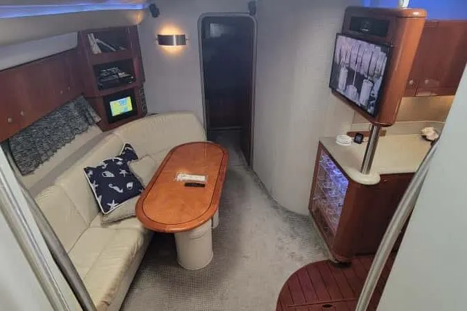  Yacht Photos Pics 2005 Formula 48 Yacht interior with cozy seating, wooden table, and entertainment area.