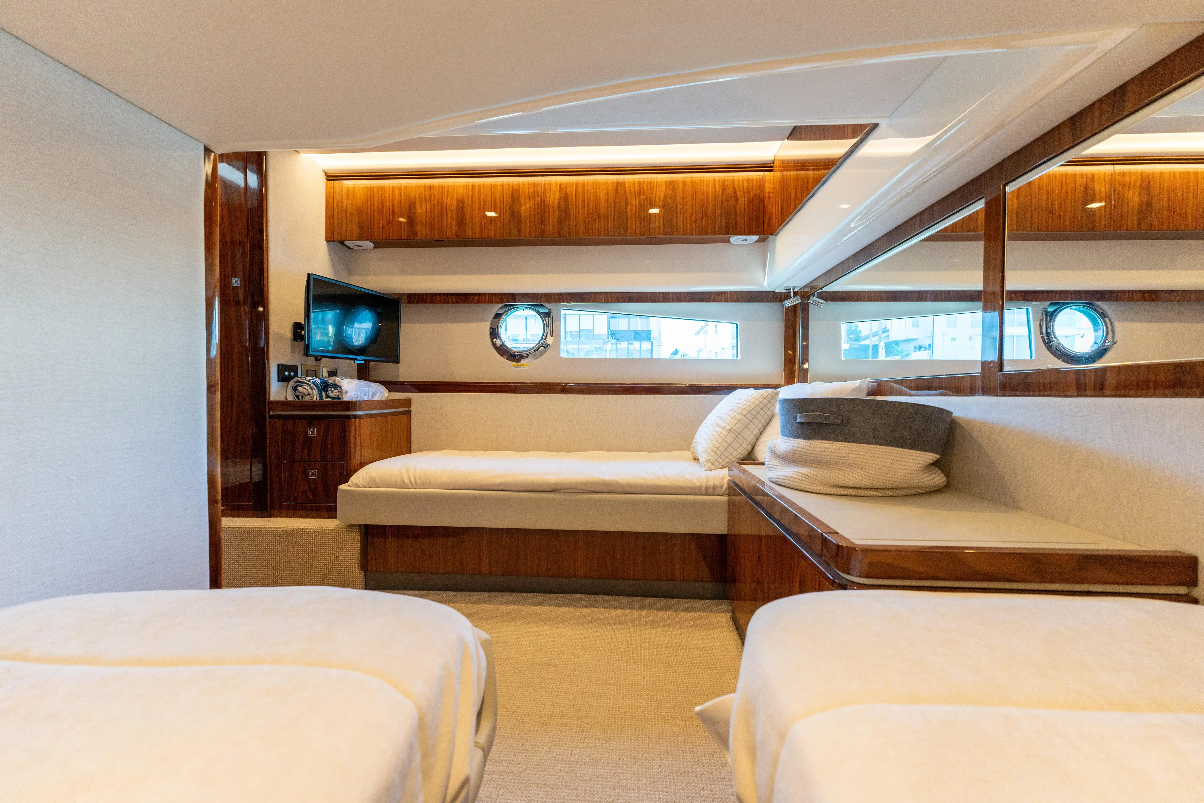 Ventures64 Yacht Photos Pics Luxurious interior of 2022 Riviera 4800 Sport Yacht with elegant wood finishes.