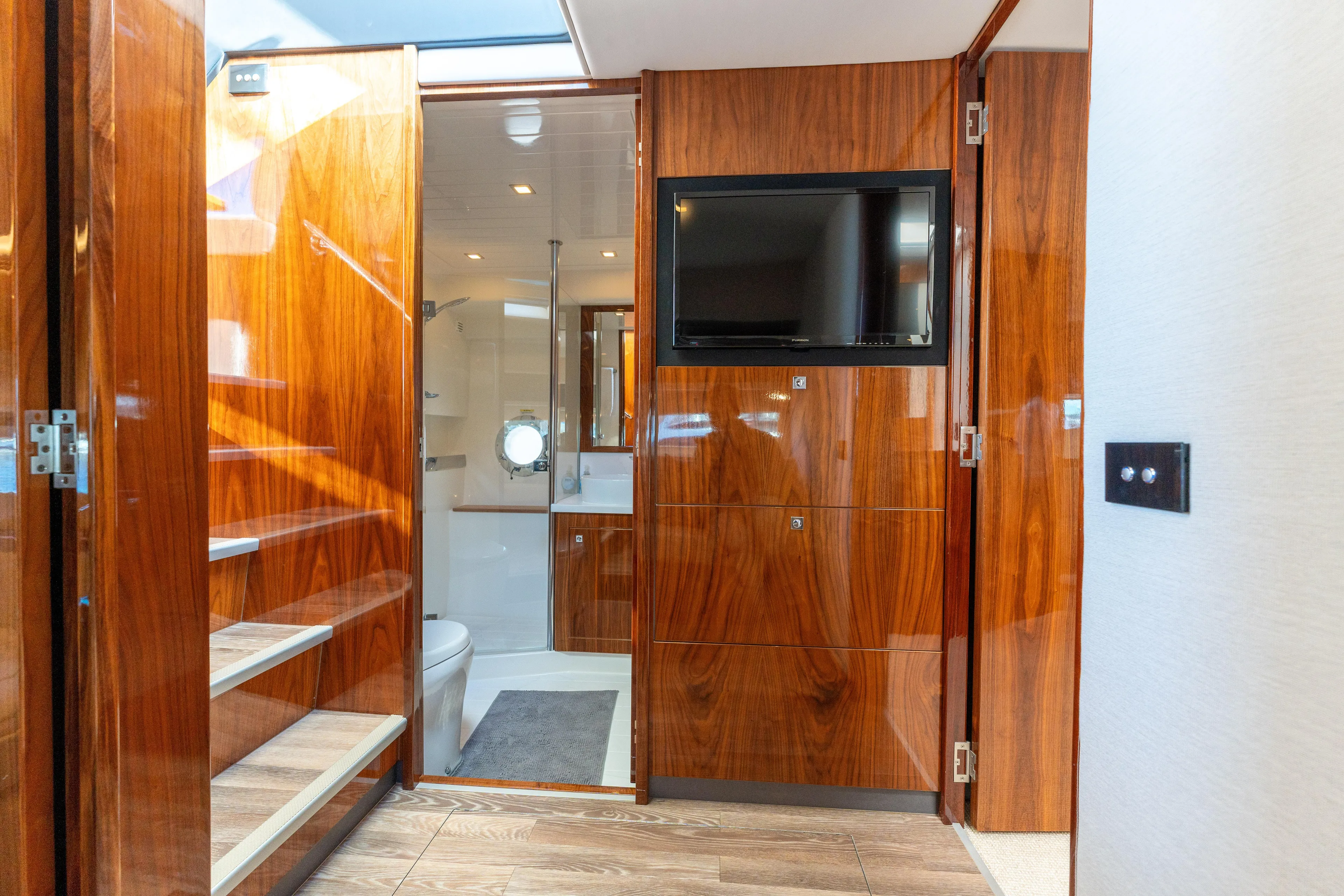 Ventures64 Yacht Photos Pics Interior of 2022 Riviera 4800 Sport Yacht with wooden finishes and modern amenities.