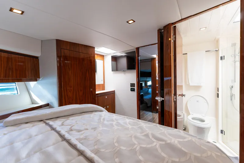 Ventures64 Yacht Photos Pics Luxurious interior of 2022 Riviera 4800 Sport Yacht bedroom and bathroom.