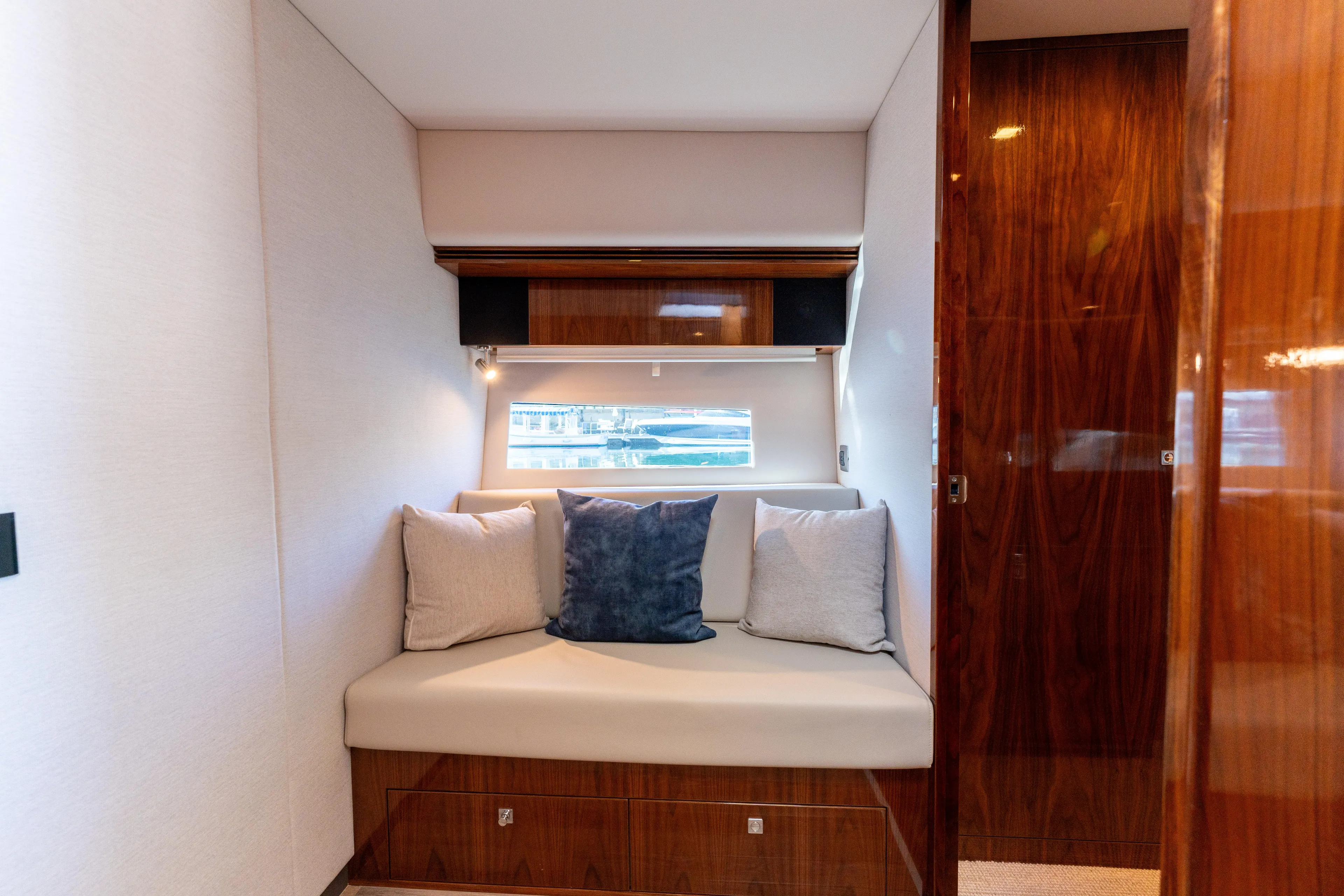 Ventures64 Yacht Photos Pics Luxurious interior of 2022 Riviera 4800 Sport Yacht with cozy seating and elegant wood finishes.