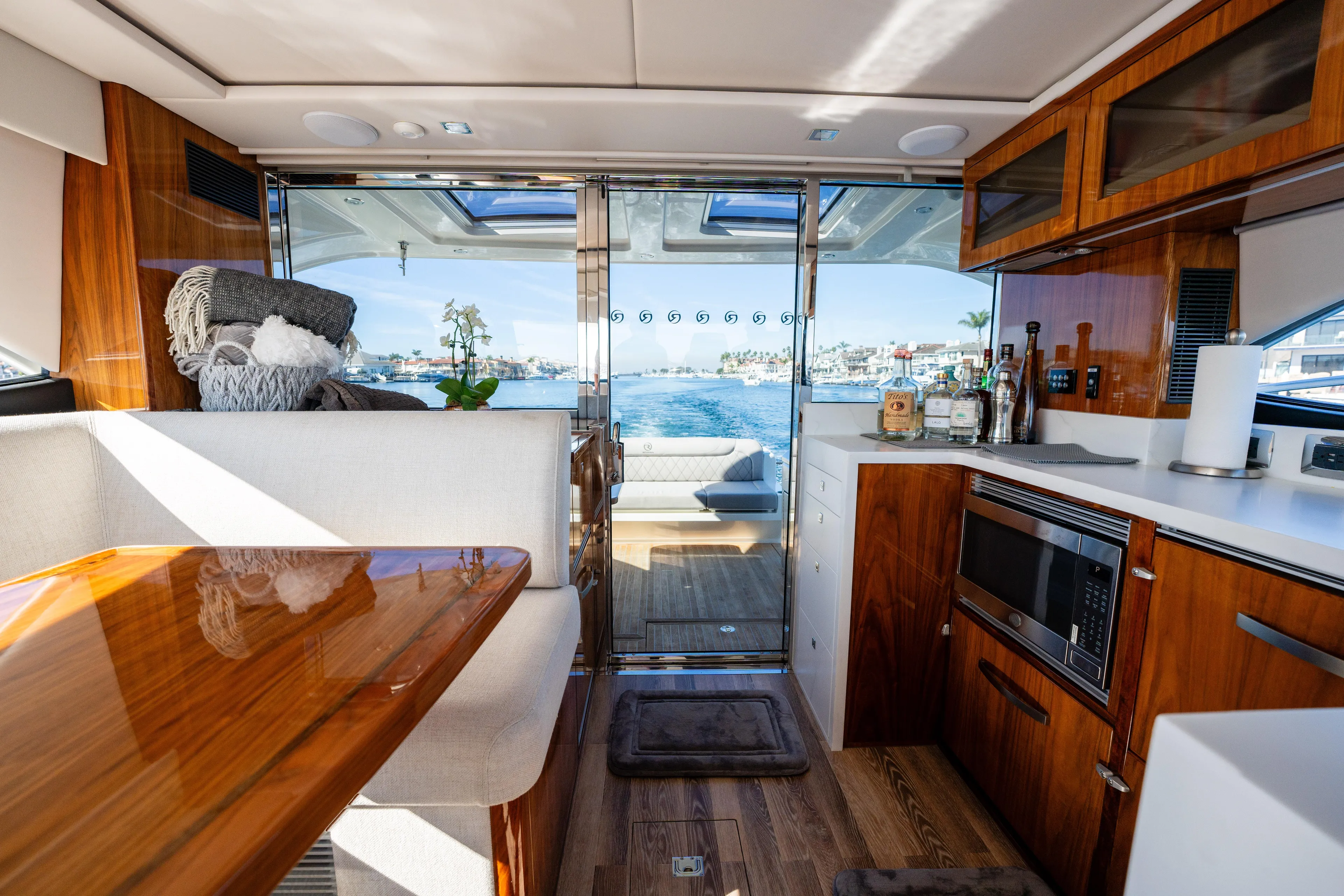 Ventures64 Yacht Photos Pics Luxurious interior of 2022 Riviera 4800 Sport Yacht with modern kitchen and scenic view.