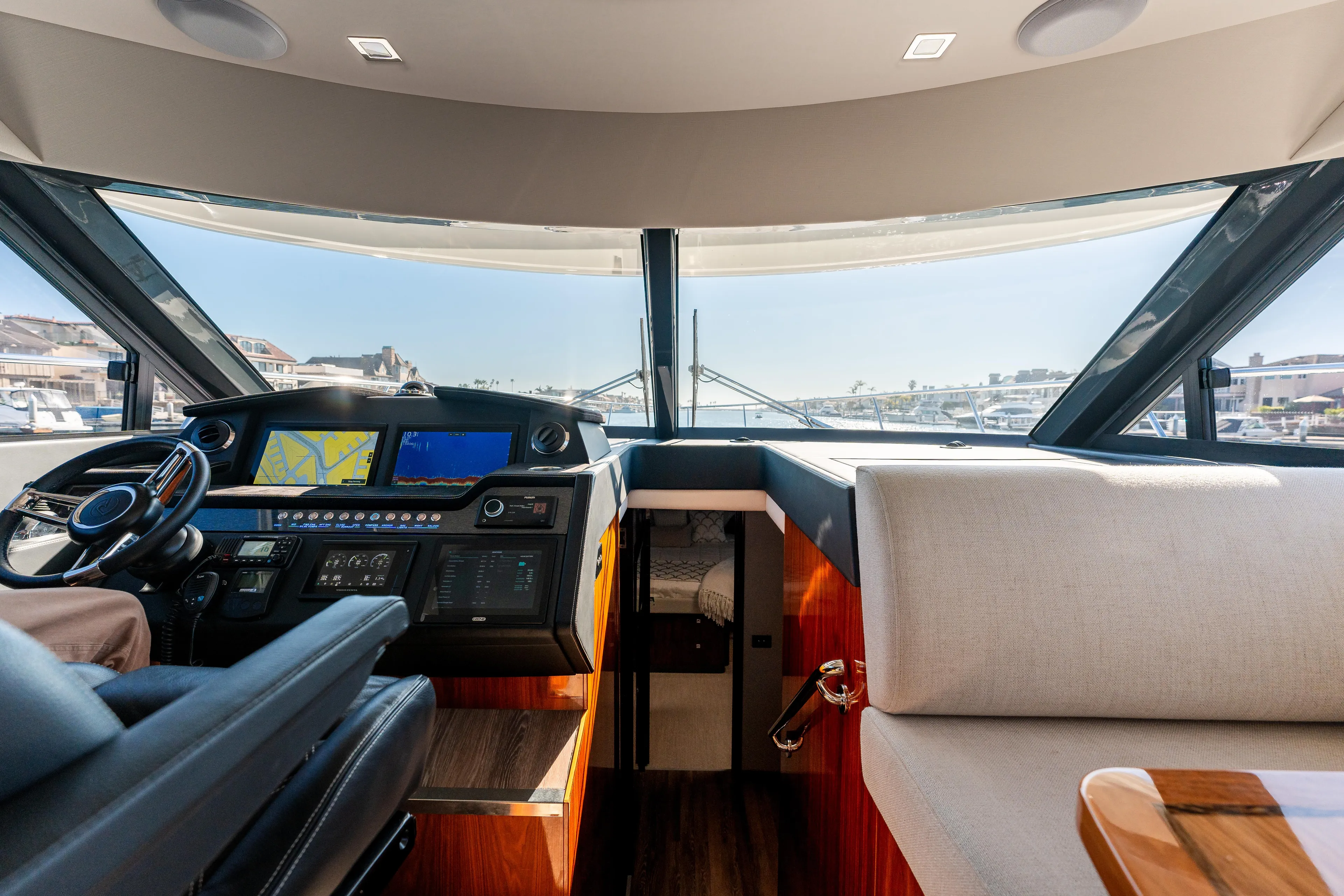 Ventures64 Yacht Photos Pics Interior view of 2022 Riviera 4800 Sport Yacht cockpit with modern controls and seating.