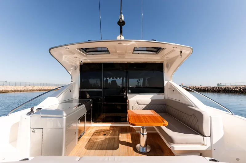 Ventures64 Yacht Photos Pics 2022 Riviera 4800 Sport Yacht with sleek deck and luxurious seating.