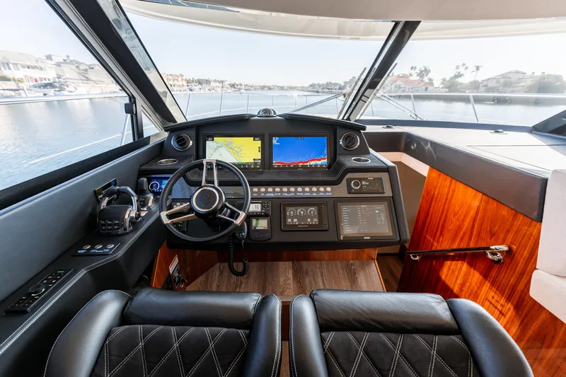 Ventures64 Yacht Photos Pics Interior cockpit of 2022 Riviera 4800 Sport Yacht with modern navigation displays.