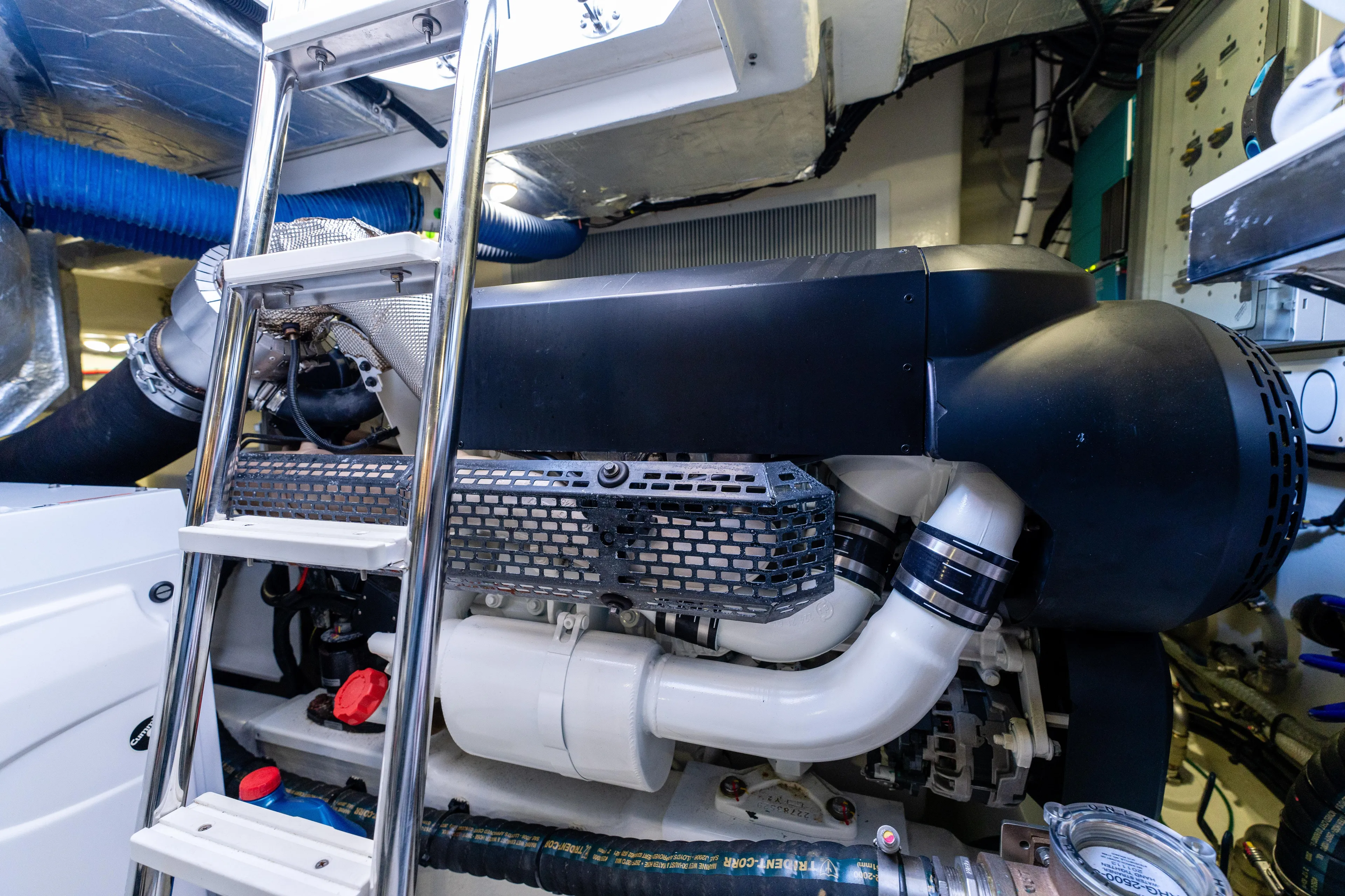 Ventures64 Yacht Photos Pics Engine room of 2022 Riviera 4800 Sport Yacht with visible components and ladder.