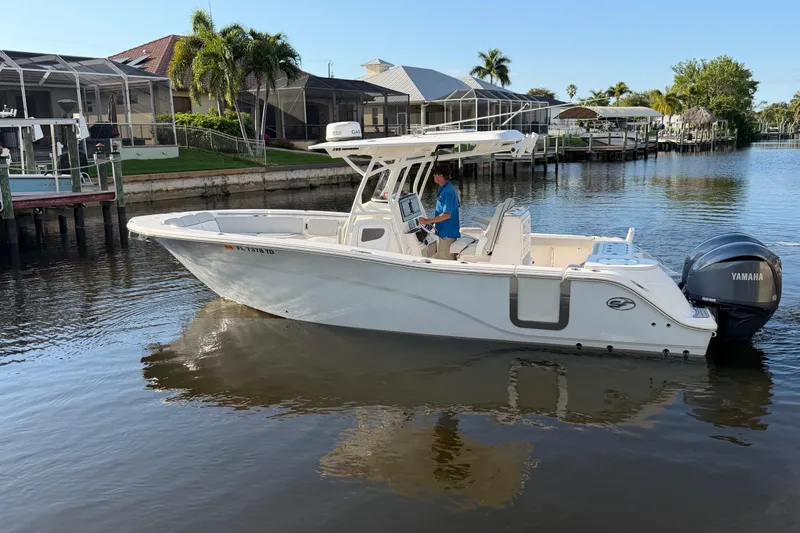  Yacht Photos Pics 2022 Sea Fox 288 Commander boat on calm water near residential docks.