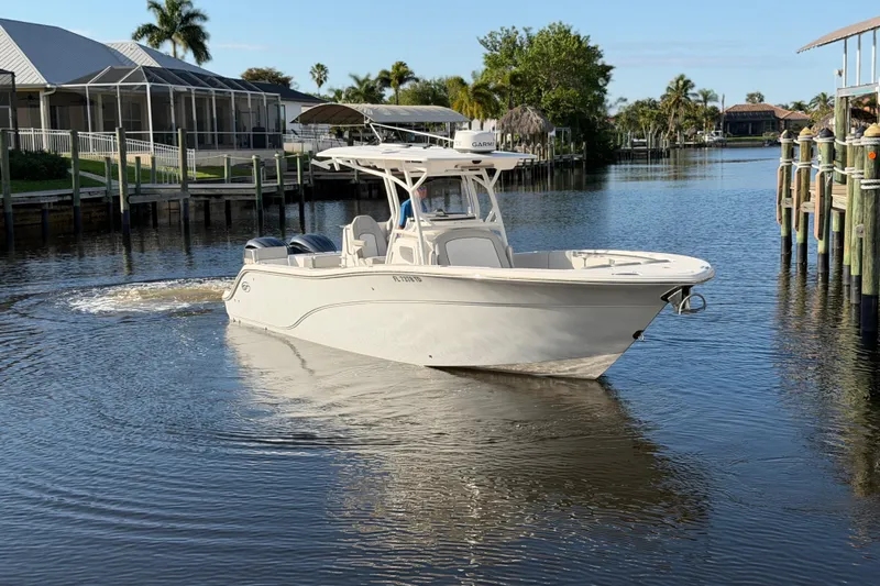  Yacht Photos Pics 2022 Sea Fox 288 Commander boat cruising in a calm residential canal.