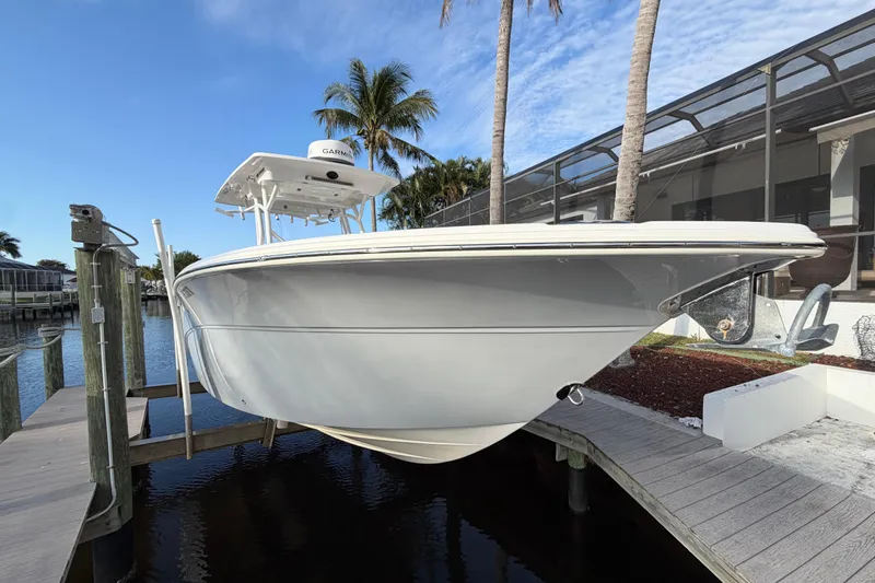  Yacht Photos Pics 2022 Sea Fox 288 Commander boat docked near palm trees and waterfront home.