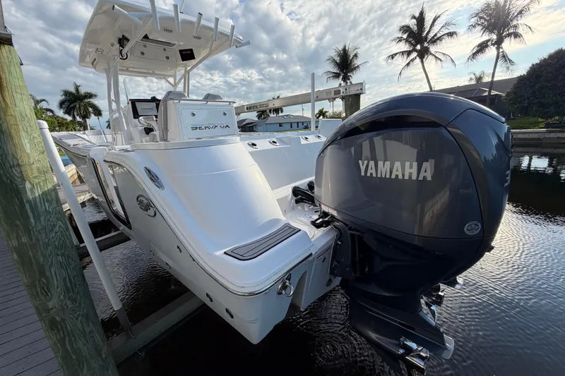  Yacht Photos Pics 2022 Sea Fox 288 Commander boat with Yamaha engine docked by palm trees.
