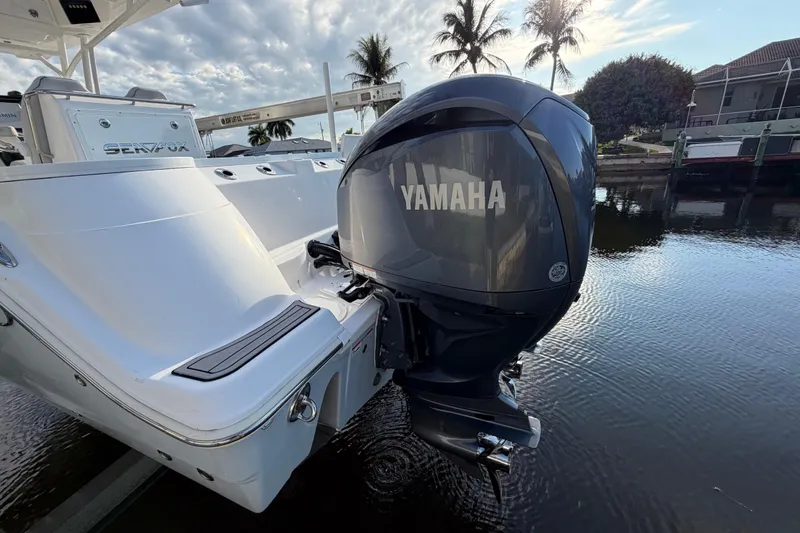  Yacht Photos Pics 2022 Sea Fox 288 Commander boat with Yamaha outboard motor, docked by palm trees.