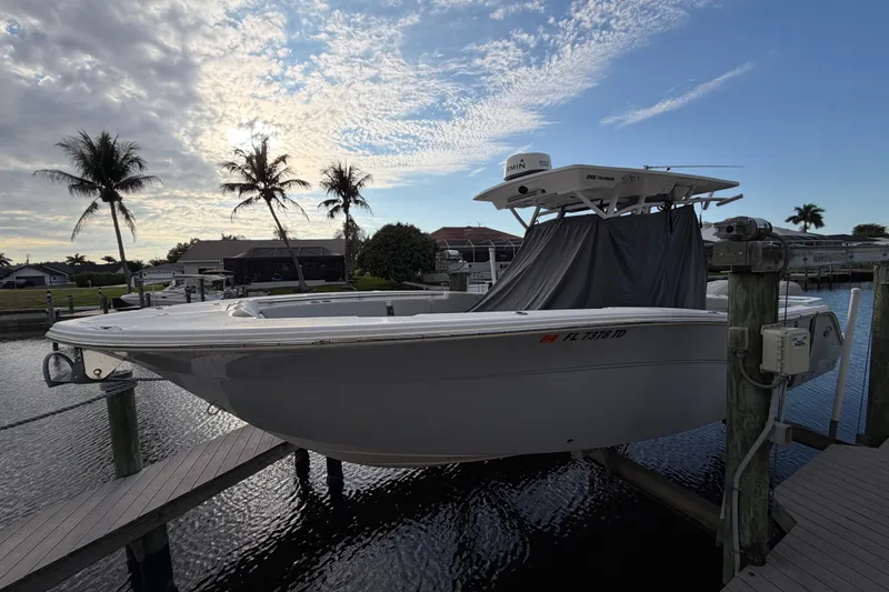  Yacht Photos Pics 2022 Sea Fox 288 Commander boat docked with palm trees and cloudy sky backdrop.