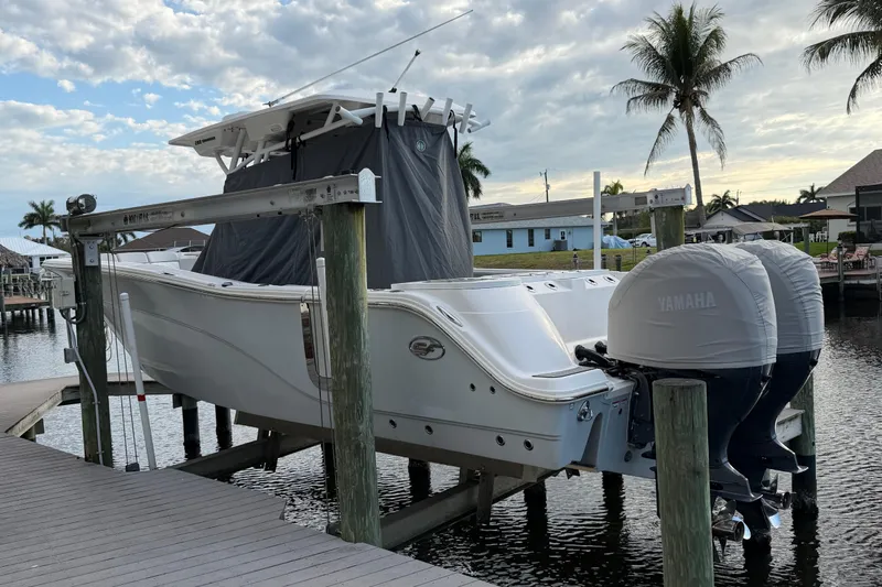  Yacht Photos Pics 2022 Sea Fox 288 Commander boat docked with Yamaha engines, palm trees in background.
