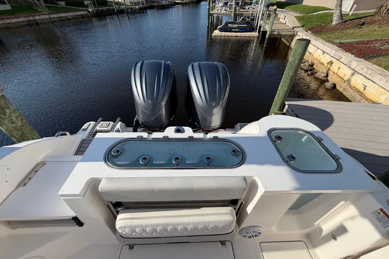 Yacht Photos Pics 2022 Sea Fox 288 Commander boat with dual engines docked by a serene waterfront.