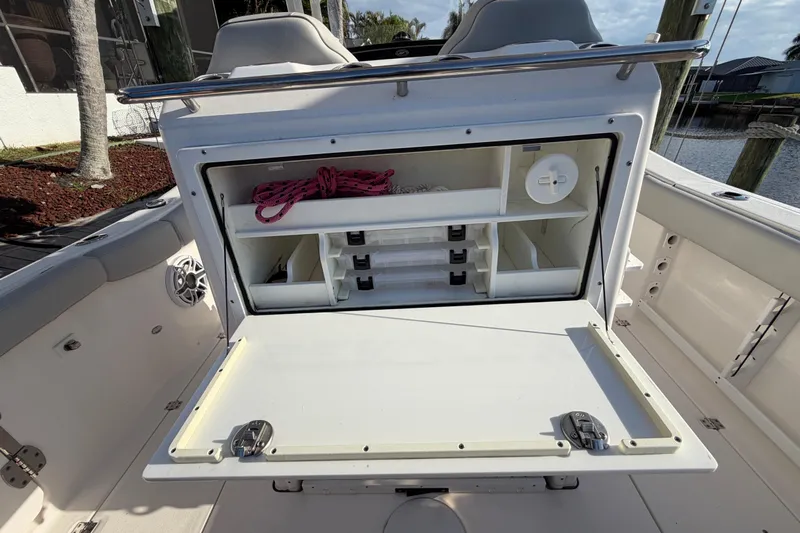  Yacht Photos Pics 2022 Sea Fox 288 Commander boat storage compartment with organized shelves and rope.