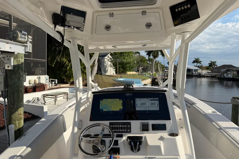  Yacht Photos Pics 2022 Sea Fox 288 Commander boat interior with navigation system, docked by a canal.