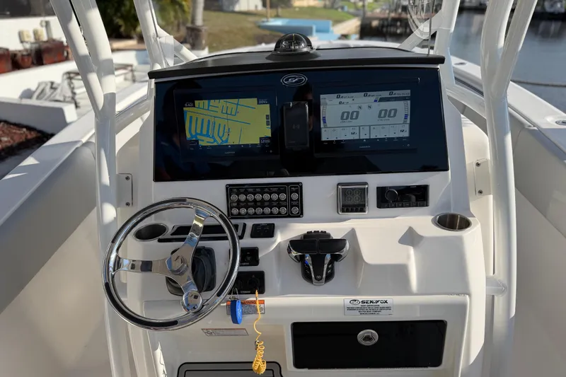  Yacht Photos Pics 2022 Sea Fox 288 Commander dashboard with navigation screens and steering wheel.