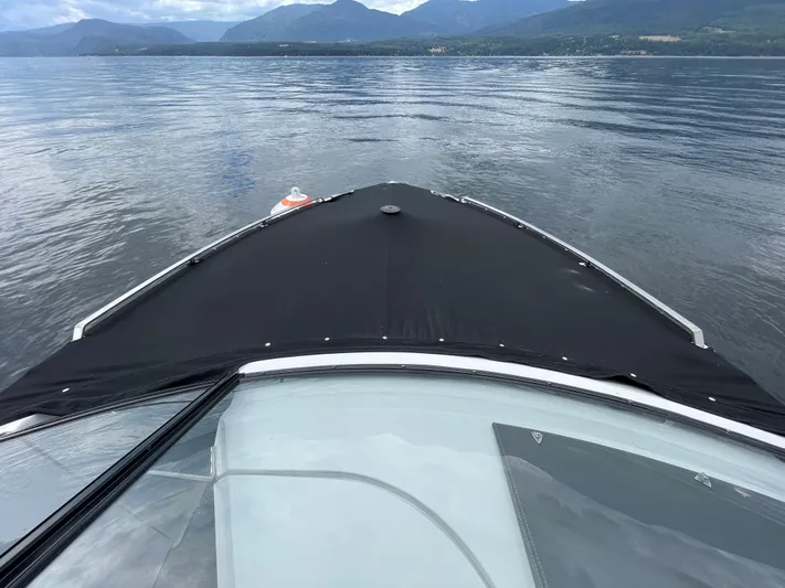  Yacht Photos Pics 2020 Cobalt A29 boat cruising on a calm lake with mountainous backdrop.