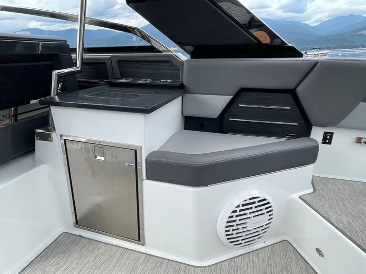  Yacht Photos Pics 2020 Cobalt A29 boat interior with seating, storage, and speaker, featuring sleek design elements.