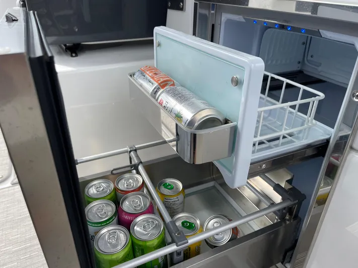  Yacht Photos Pics Mini fridge with assorted beverage cans inside a 2020 Cobalt A29 boat.