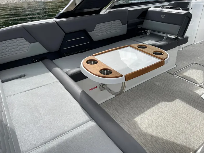  Yacht Photos Pics 2020 Cobalt A29 boat interior with sleek seating and a stylish wooden table.