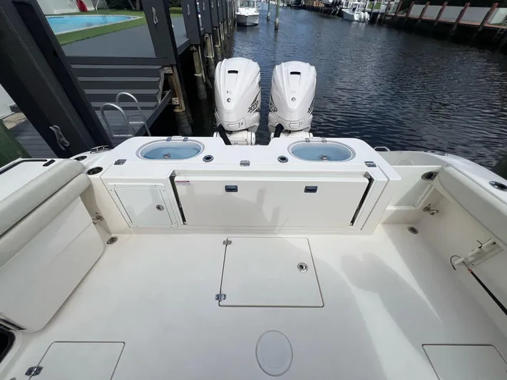  Yacht Photos Pics 2020 Cobia 350 boat deck with dual outboard engines, docked by the water.
