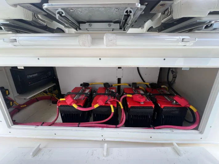  Yacht Photos Pics Battery compartment of 2020 Cobia 350 boat with multiple red batteries and wiring.