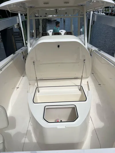  Yacht Photos Pics 2020 Cobia 350 boat with open storage compartment, docked by the water.