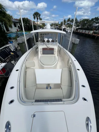 Yacht Photos Pics 2020 Cobia 350 boat with spacious deck, docked in a scenic canal setting.