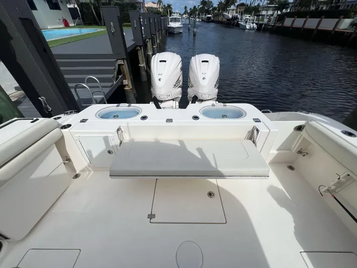  Yacht Photos Pics 2020 Cobia 350 boat with dual engines docked by a canal.