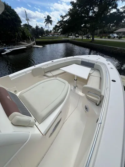  Yacht Photos Pics 2020 Cobia 350 boat with spacious seating and table on a calm waterway.