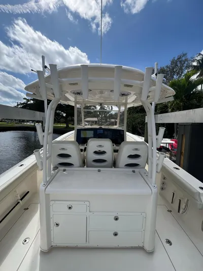  Yacht Photos Pics 2020 Cobia 350 boat interior with helm station, white seating, and clear sky background.