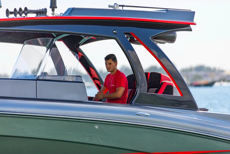  Yacht Photos Pics Man piloting 2021 Concept 44' Open Deck boat on water.