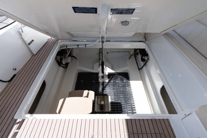 Middle Path Yacht Photos Pics 2023 MJM 4 boat engine compartment with open hatch, showcasing interior details.