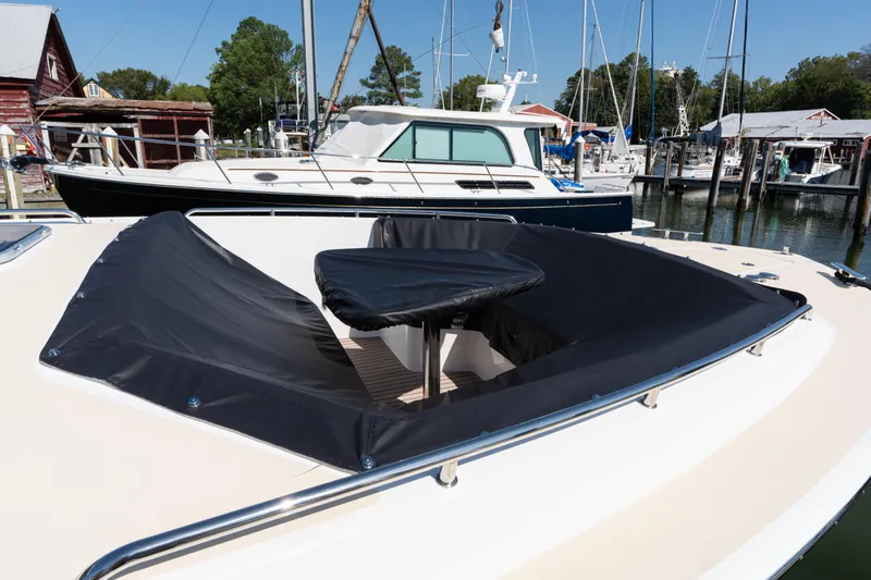 Middle Path Yacht Photos Pics 2023 MJM 4 boat with covered seating area at a marina.