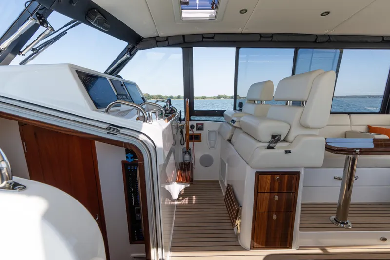 Middle Path Yacht Photos Pics 2023 MJM Yachts 4 interior with helm, luxurious seating, and wooden accents.