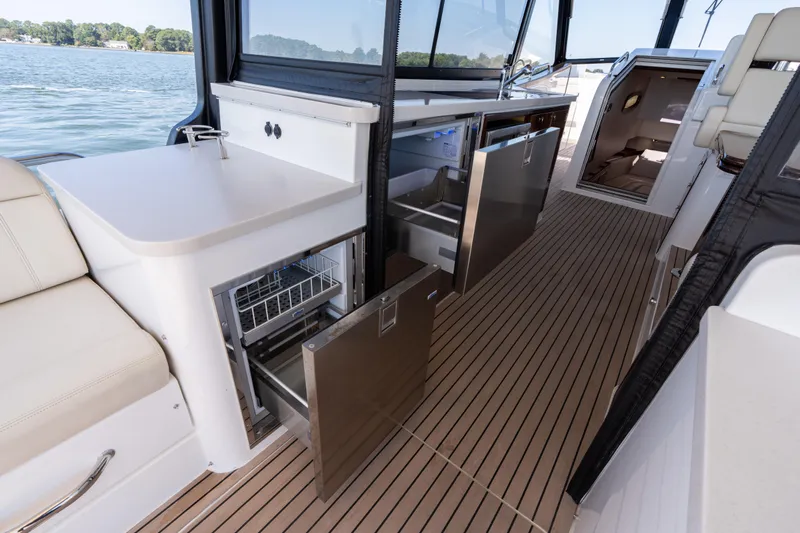 Middle Path Yacht Photos Pics Luxurious 2023 MJM Yachts 4 interior with modern kitchen and seating area on deck.