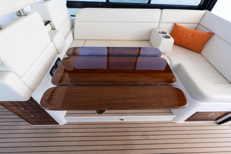 Middle Path Yacht Photos Pics Luxurious 2023 MJM Yachts 4 interior with elegant wood table and white seating.