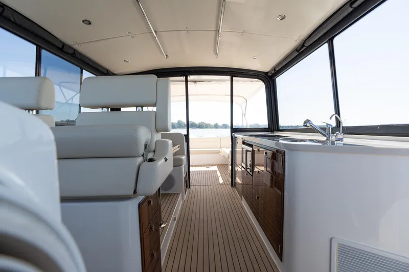 Middle Path Yacht Photos Pics Interior of 2023 MJM Yachts 4, featuring luxurious seating and modern kitchenette.