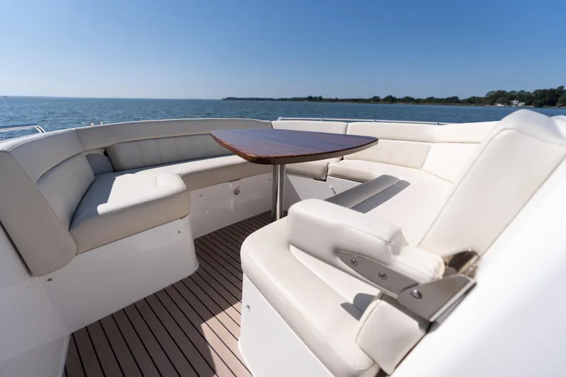 Middle Path Yacht Photos Pics Luxurious seating area on 2023 MJM Yachts 4, overlooking serene ocean view.