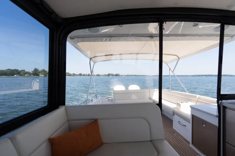 Middle Path Yacht Photos Pics Interior view of 2023 MJM Yachts 4, showcasing spacious seating and scenic water backdrop.