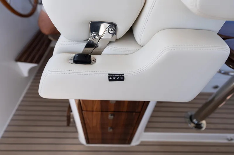 Middle Path Yacht Photos Pics Luxury seating detail on 2023 MJM Yachts 4, featuring white upholstery and control buttons.